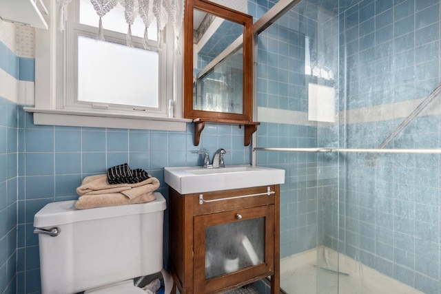 bathroom featuring tasteful backsplash, tile walls, vanity, an enclosed shower, and toilet