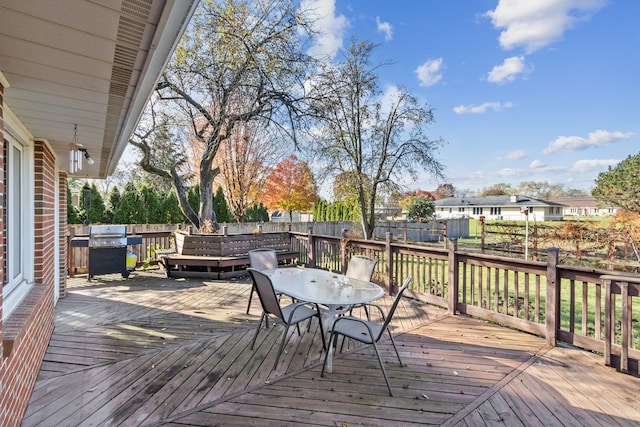 wooden deck with a grill