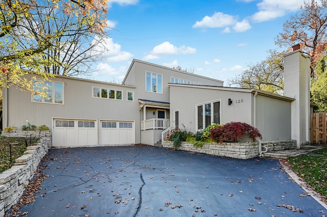 rear view of house featuring a garage