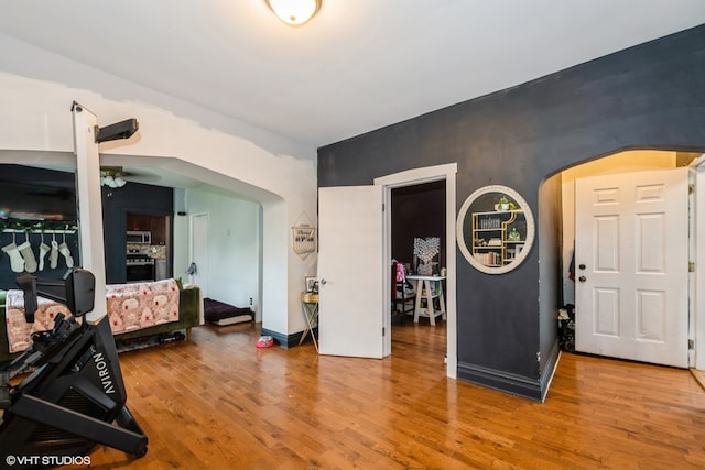 interior space with lofted ceiling, hardwood / wood-style flooring, and ceiling fan