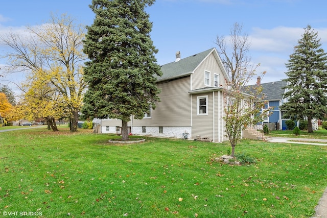 view of home's exterior with a garage and a yard