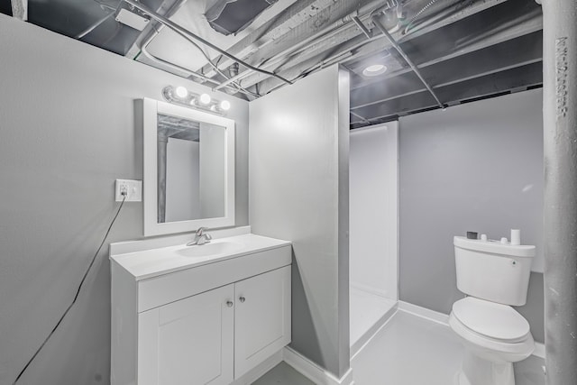 bathroom featuring vanity, toilet, and walk in shower