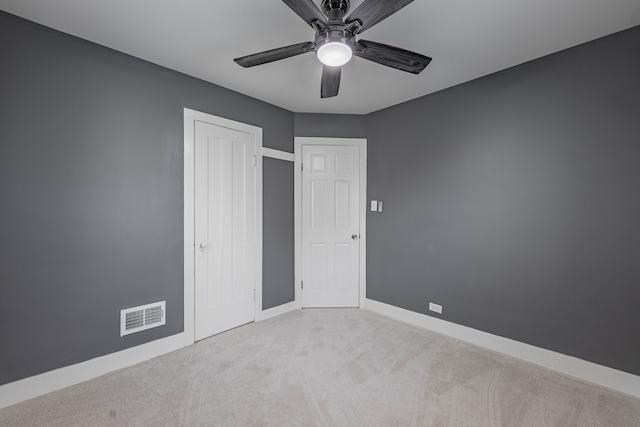 unfurnished bedroom with ceiling fan and light carpet