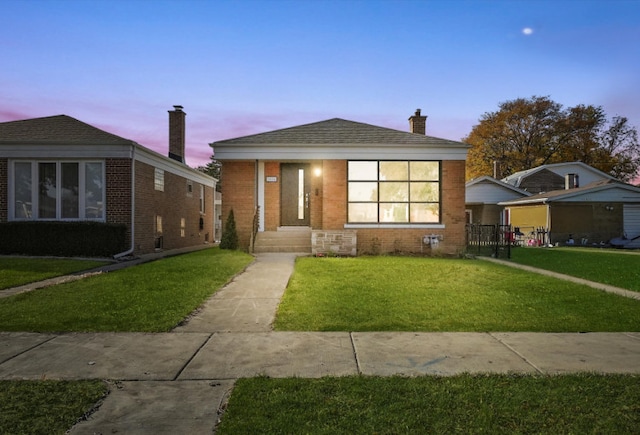 view of front of property with a yard