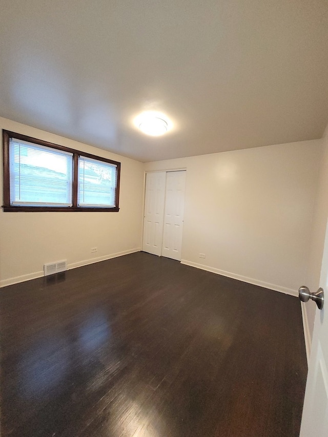 spare room featuring dark hardwood / wood-style floors