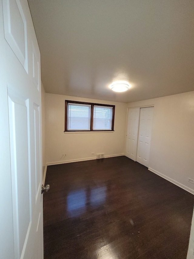 empty room featuring dark wood-type flooring