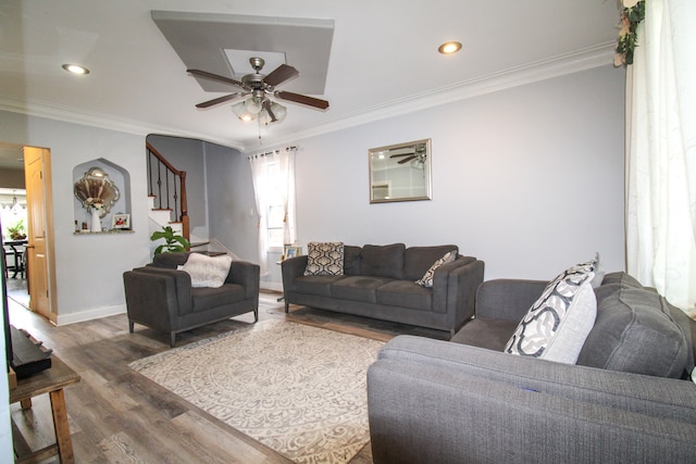 living room featuring ceiling fan, wood-type flooring, and crown molding