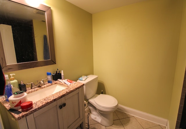 bathroom featuring toilet, vanity, and tile patterned floors