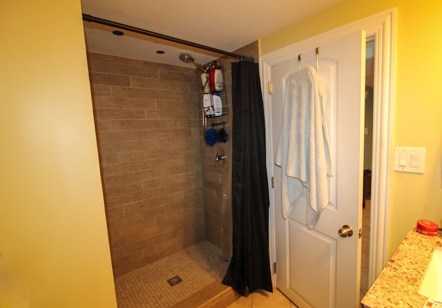 bathroom with a shower with curtain, vanity, and tile patterned flooring