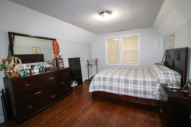 bedroom featuring dark hardwood / wood-style flooring and vaulted ceiling