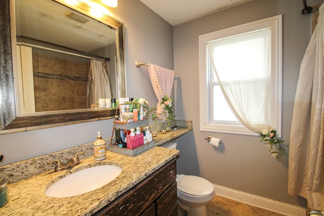 bathroom featuring toilet, a shower with curtain, vanity, and tile patterned flooring