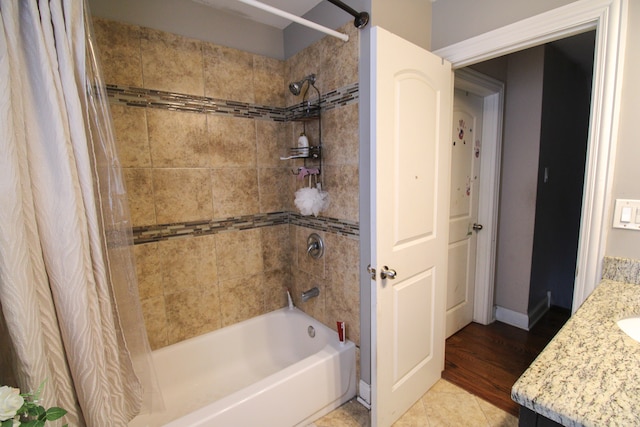 bathroom with shower / bath combo, wood-type flooring, and vanity