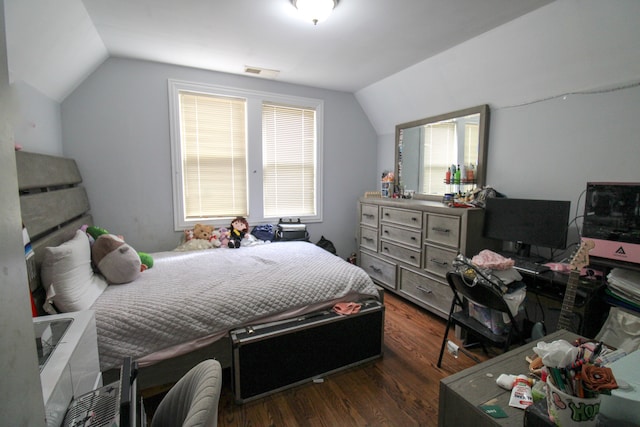 bedroom featuring dark wood-type flooring and lofted ceiling