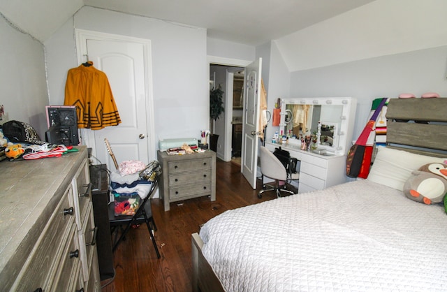 bedroom with dark hardwood / wood-style floors and lofted ceiling