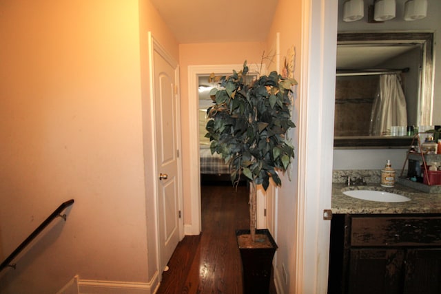 hallway with sink and dark hardwood / wood-style flooring