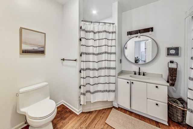 full bathroom with toilet, vanity, hardwood / wood-style floors, and shower / bathtub combination with curtain