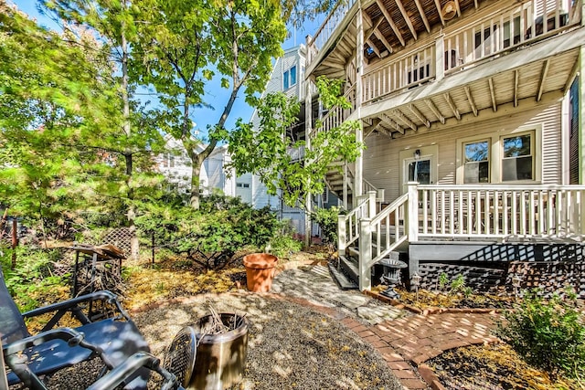 view of yard featuring an outdoor fire pit and a balcony