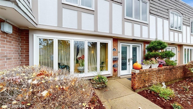 704 Lorraine Cir, Highland Park, IL 60035 - view of exterior entry featuring brick siding and stucco siding