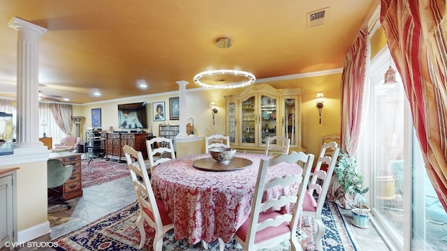 dining room featuring a healthy amount of sunlight, ornate columns, and crown molding