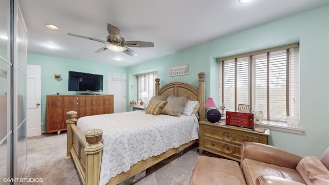 bedroom with ceiling fan and light colored carpet