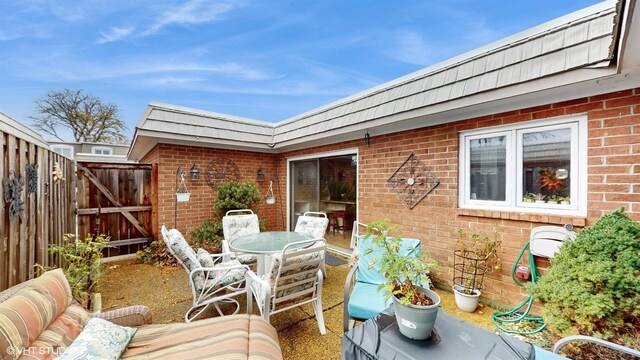 704 Lorraine Cir, Highland Park, IL 60035 - view of patio / terrace with a gate, outdoor dining area, and fence