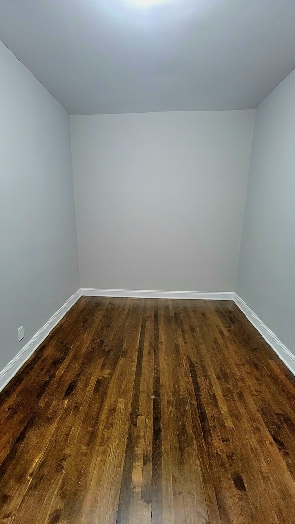 empty room with dark wood-type flooring