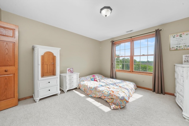 bedroom featuring light colored carpet