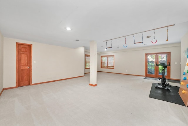 workout room with light colored carpet, rail lighting, and french doors