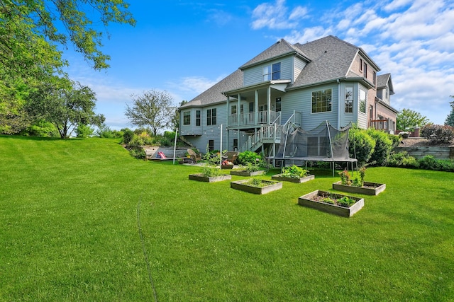 back of house with a lawn