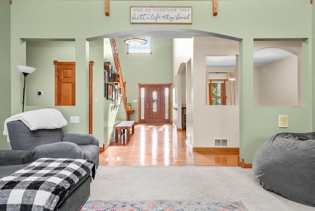 entryway featuring hardwood / wood-style flooring and a high ceiling