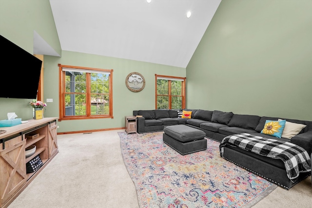 living room featuring high vaulted ceiling and light carpet