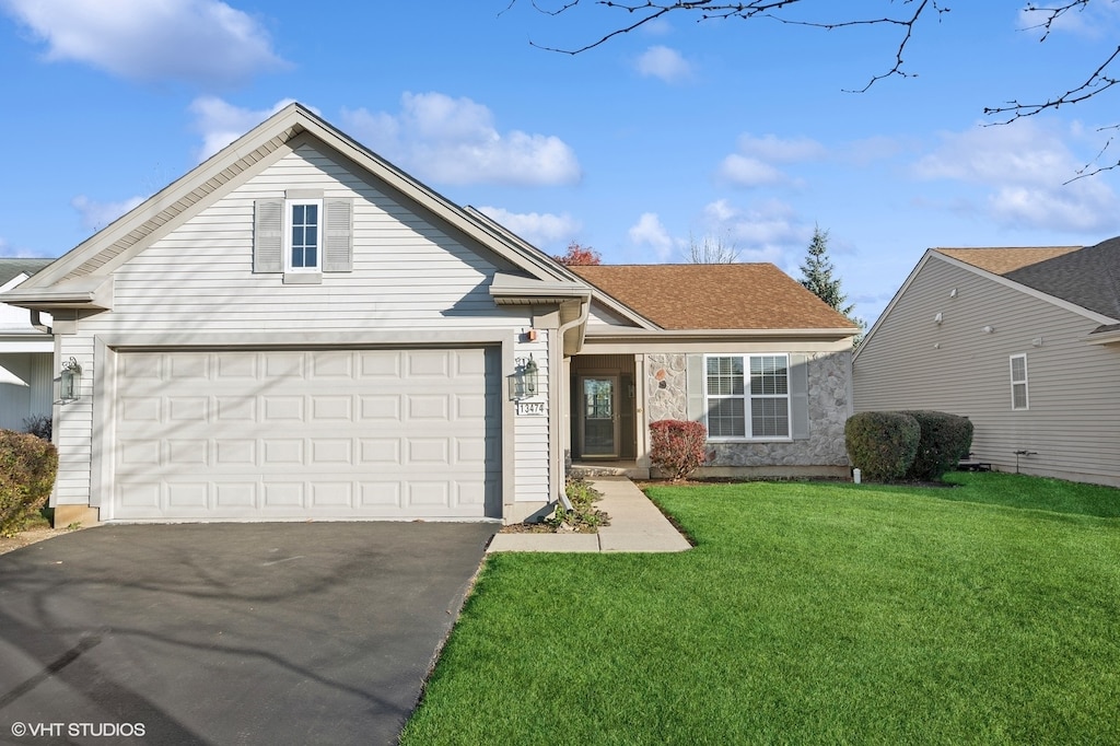 view of front of house with a front lawn and a garage