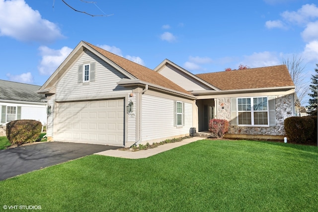 view of front of property with a front lawn and a garage