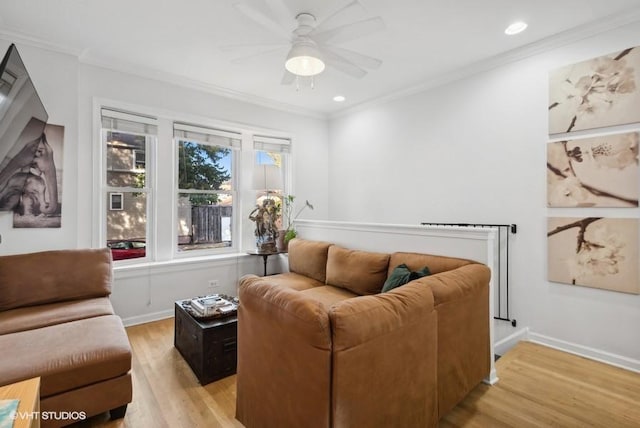 living room with light hardwood / wood-style flooring, ceiling fan, and ornamental molding