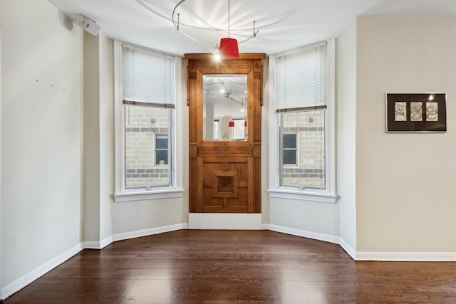 empty room featuring dark hardwood / wood-style flooring