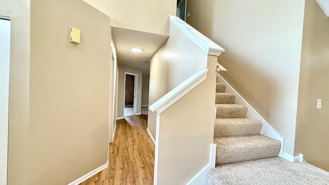 staircase with hardwood / wood-style flooring