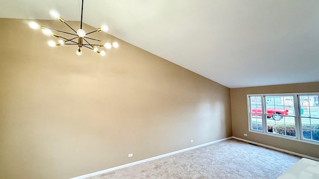 carpeted spare room with vaulted ceiling and a notable chandelier