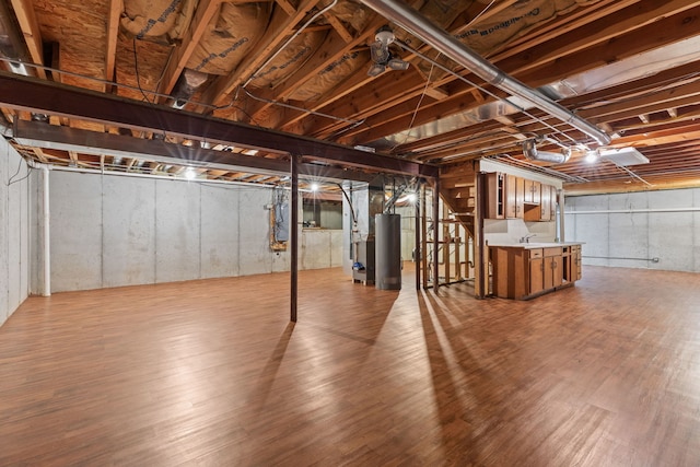 basement with gas water heater and wood-type flooring