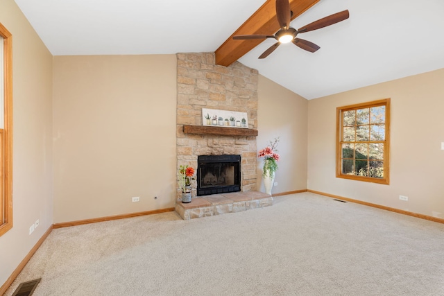 unfurnished living room with vaulted ceiling with beams, ceiling fan, a fireplace, and light carpet