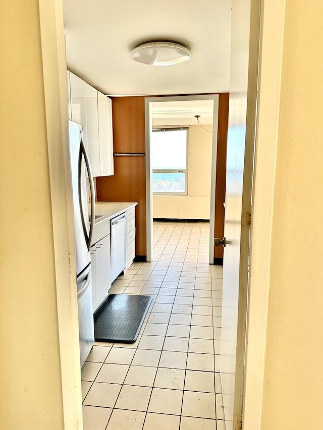 2626 N Lakeview Ave Unit 1503, Chicago, IL 60614 - kitchen featuring light tile patterned floors, white cabinets, appliances with stainless steel finishes, and light countertops