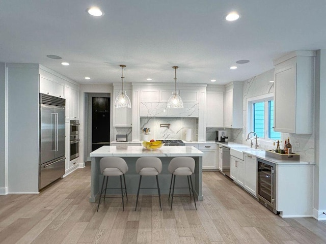 5S504 Radcliff Rd, Naperville, IL 60563 - kitchen featuring wine cooler, stainless steel appliances, a kitchen bar, a kitchen island, and backsplash
