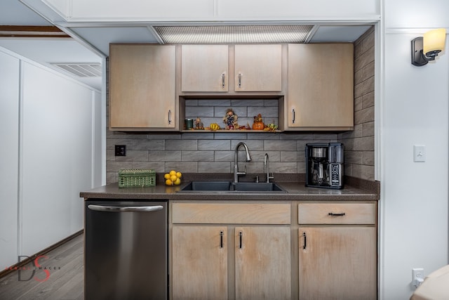 kitchen featuring sink, tasteful backsplash, light brown cabinetry, stainless steel dishwasher, and light hardwood / wood-style flooring