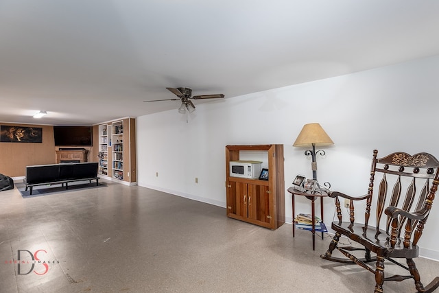 sitting room featuring ceiling fan