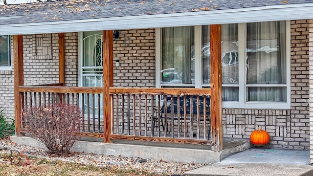 view of exterior entry featuring covered porch