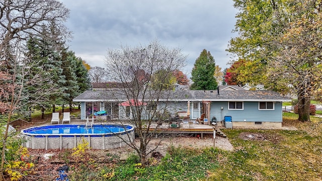 back of house with a pool side deck