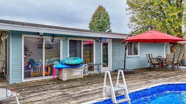 rear view of house with a swimming pool side deck