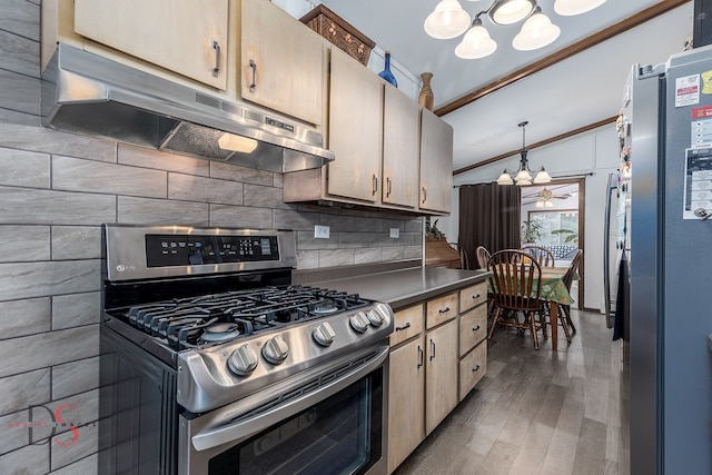 kitchen featuring dark wood-type flooring, hanging light fixtures, a notable chandelier, crown molding, and appliances with stainless steel finishes