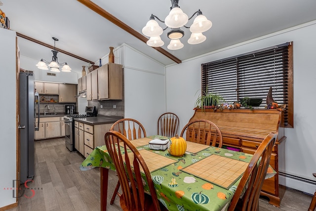 dining area featuring hardwood / wood-style flooring, lofted ceiling, a notable chandelier, and a baseboard heating unit