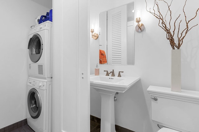 washroom featuring stacked washer and dryer