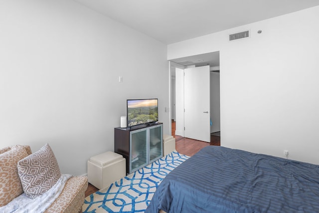 bedroom with dark wood-type flooring